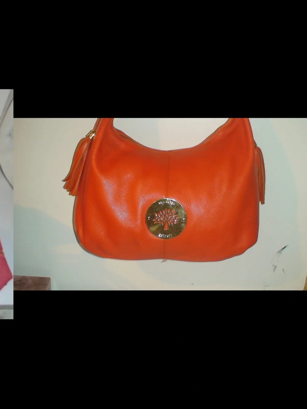 Mulberry Orange Leather Hobo Bag with Tassels and Gold Emblem